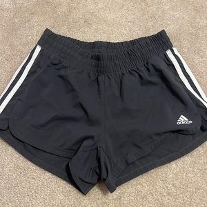 Dark grey athletic Adidas shorts.